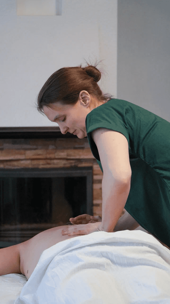 Massage therapist giving a back massage.
